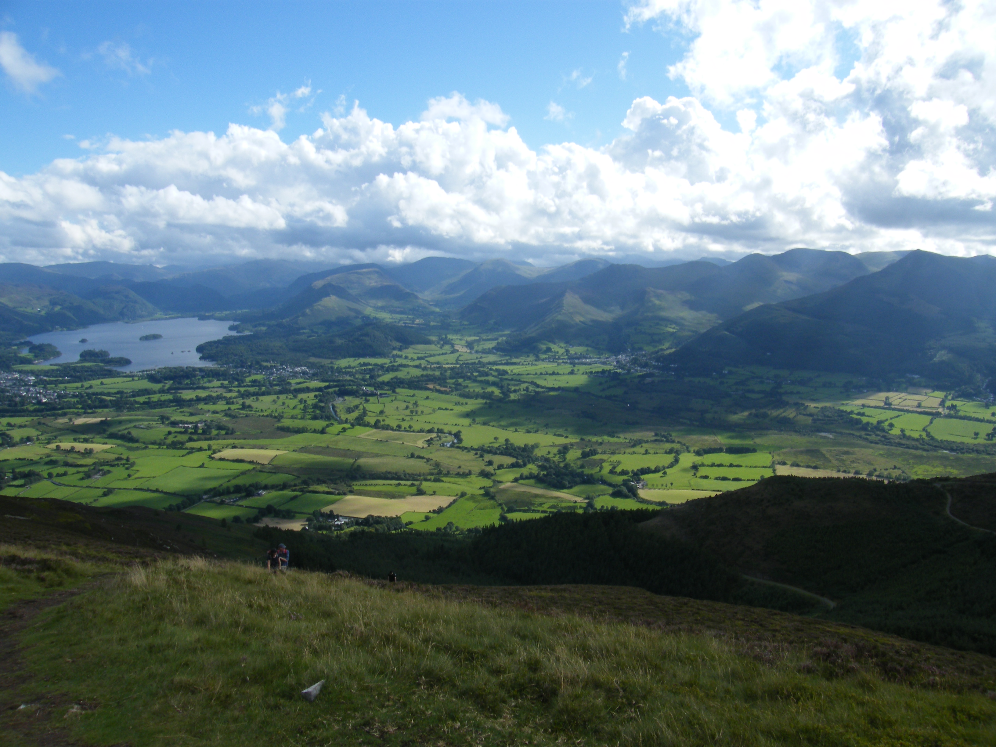 green countryside surrounded by mountains
